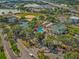 Aerial view showing community amenities including pool, clubhouse, tennis courts, and parking at 11799 Se 173Rd Lane Rd, Summerfield, FL 34491