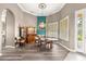 Formal dining area featuring wood floors, custom lighting, and an elegant display cabinet at 11799 Se 173Rd Lane Rd, Summerfield, FL 34491
