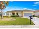 Inviting home with a well-manicured lawn, charming curb appeal, and a convenient two-car garage at 11799 Se 173Rd Lane Rd, Summerfield, FL 34491