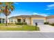 Inviting home with well-manicured lawn, charming curb appeal, and a convenient two-car garage at 11799 Se 173Rd Lane Rd, Summerfield, FL 34491