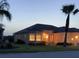 Well-lit home showcasing a manicured lawn and a welcoming entrance at 11799 Se 173Rd Lane Rd, Summerfield, FL 34491