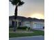 Charming single-story home boasts a two-car garage and a well-maintained front yard with a palm tree at 11799 Se 173Rd Lane Rd, Summerfield, FL 34491