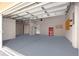 Spacious garage featuring durable flooring, ample storage cabinets, and a convenient tool chest at 11799 Se 173Rd Lane Rd, Summerfield, FL 34491