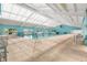Bright indoor pool area featuring high ceilings and ample seating at 11799 Se 173Rd Lane Rd, Summerfield, FL 34491