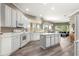 Bright kitchen equipped with white cabinets, central island, and views of the backyard at 11799 Se 173Rd Lane Rd, Summerfield, FL 34491