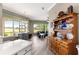 Open-concept kitchen with an antique hutch, bar seating and views into the cozy living space at 11799 Se 173Rd Lane Rd, Summerfield, FL 34491