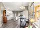 Spacious kitchen with white cabinets, a central island, and breakfast bar with views to the lanai at 11799 Se 173Rd Lane Rd, Summerfield, FL 34491