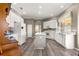 Well-lit kitchen featuring white cabinetry, stainless steel appliances, and center island on wood-look floors at 11799 Se 173Rd Lane Rd, Summerfield, FL 34491