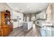 Bright kitchen with white cabinets, stainless appliances, center island and charming antique cabinet on wood floors at 11799 Se 173Rd Lane Rd, Summerfield, FL 34491