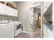 Bright laundry room with modern appliances and built-in storage cabinets at 11799 Se 173Rd Lane Rd, Summerfield, FL 34491