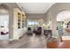 Inviting living room with hardwood floors and a custom built-in bookcase; natural light illuminates the space at 11799 Se 173Rd Lane Rd, Summerfield, FL 34491