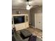 Cozy living room with neutral colors, ceiling fan and a large entertainment center with cabinets and drawers at 11799 Se 173Rd Lane Rd, Summerfield, FL 34491