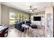 Comfortable living room with large windows, stylish decor, and sleek, modern flooring at 11799 Se 173Rd Lane Rd, Summerfield, FL 34491