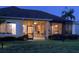 Back of house featuring a screened lanai overlooking the yard at dusk at 11799 Se 173Rd Lane Rd, Summerfield, FL 34491