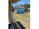 This backyard features an outdoor shed with a deck and colorful chairs, adding character to the landscape at 14 Se 62Nd Ter, Ocala, FL 34471
