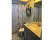 Bathroom with gray vanity, marble countertop, and blue patterned shower curtain at 14 Se 62Nd Ter, Ocala, FL 34471