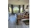 Spacious bedroom with a large bed, gray floors, and many windows at 14 Se 62Nd Ter, Ocala, FL 34471