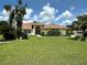 Charming single-story home with a well-manicured lawn, mature landscaping, and a welcoming arched entryway at 14 Se 62Nd Ter, Ocala, FL 34471