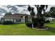 Charming yellow home with well-kept lawn and appealing landscaping details at 14 Se 62Nd Ter, Ocala, FL 34471
