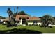 Charming yellow home with a well-manicured lawn and lush tropical landscaping at 14 Se 62Nd Ter, Ocala, FL 34471
