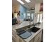 Bright kitchen with granite countertops, stainless steel sink, and open floor plan at 14 Se 62Nd Ter, Ocala, FL 34471