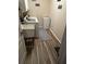Functional laundry room with wood-look floors, utility sink, washer and dryer, and extra storage space at 14 Se 62Nd Ter, Ocala, FL 34471