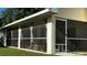 An exterior view of screened in porch, showing the ample space and screening at 14 Se 62Nd Ter, Ocala, FL 34471
