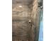 This shower has beautiful stone-look tile, pebble stone floor, and updated shower head and fixtures at 14 Se 62Nd Ter, Ocala, FL 34471