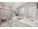 A stylish bathroom with a double vanity, sleek fixtures, and a glass-enclosed shower at 15769 Sw 37Th Cir, Ocala, FL 34473