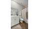 Clean bathroom featuring single sink, wood-look floors, and shower with curtain and neutral palette at 15769 Sw 37Th Cir, Ocala, FL 34473