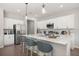 Bright, modern kitchen with an island featuring barstool seating, stainless appliances, and white cabinetry at 15769 Sw 37Th Cir, Ocala, FL 34473
