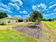 Lush backyard with well-manicured lawn and mulched flowerbeds under a vibrant sky at 15782 Sw 16Th Avenue Rd, Ocala, FL 34473