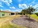Lush backyard with well-manicured lawn and mulched flowerbeds under a vibrant sky at 15782 Sw 16Th Avenue Rd, Ocala, FL 34473