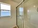 Bathroom features a tiled shower stall, window, and neutral finishes at 15782 Sw 16Th Avenue Rd, Ocala, FL 34473