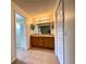 Bathroom with double sink vanity, tiled floors, and walk-in shower with glass door at 15782 Sw 16Th Avenue Rd, Ocala, FL 34473