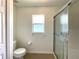 Bathroom features a toilet, window, and tiled shower stall at 15782 Sw 16Th Avenue Rd, Ocala, FL 34473