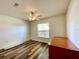 Bedroom with wood-look floors, ceiling fan and window at 15782 Sw 16Th Avenue Rd, Ocala, FL 34473