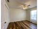 Bedroom featuring hardwood floors, ceiling fan, and natural light from the window at 15782 Sw 16Th Avenue Rd, Ocala, FL 34473