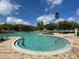 Stunning community pool with clear blue water, palm trees, and lounge areas at 15782 Sw 16Th Avenue Rd, Ocala, FL 34473