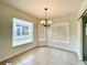 Bright dining area with tile floors, chandelier and multiple windows for ample natural light at 15782 Sw 16Th Avenue Rd, Ocala, FL 34473