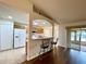 Eat-in kitchen features a breakfast bar, white appliances and opens to the living room and patio at 15782 Sw 16Th Avenue Rd, Ocala, FL 34473