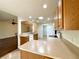 Bright, spacious kitchen with tile flooring and light wood cabinets with a view to the living area at 15782 Sw 16Th Avenue Rd, Ocala, FL 34473