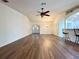 Bright open living space with hardwood floors, ceiling fan, and view of the entry and breakfast bar at 15782 Sw 16Th Avenue Rd, Ocala, FL 34473