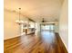 Spacious living room with hardwood floors and a view to the kitchen, dining area, and screened in patio at 15782 Sw 16Th Avenue Rd, Ocala, FL 34473