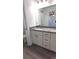 Updated bathroom featuring a double vanity with granite countertop and new hardware at 20 Malauka Pass Crse, Ocklawaha, FL 32179