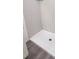 Bathroom featuring a large shower with sleek gray tile and glass shelf at 20 Malauka Pass Crse, Ocklawaha, FL 32179