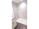Bathroom featuring a large shower with sleek white tile and glass shelf at 20 Malauka Pass Crse, Ocklawaha, FL 32179