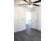 Bedroom with wood-look floors and two doors, allowing plenty of natural light at 20 Malauka Pass Crse, Ocklawaha, FL 32179