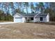 Inviting single-story home with a two-car garage, driveway, and minimal landscaping at 20 Malauka Pass Crse, Ocklawaha, FL 32179
