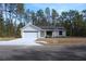 Charming single-story home featuring a two-car garage and a neatly landscaped front yard at 20 Malauka Pass Crse, Ocklawaha, FL 32179